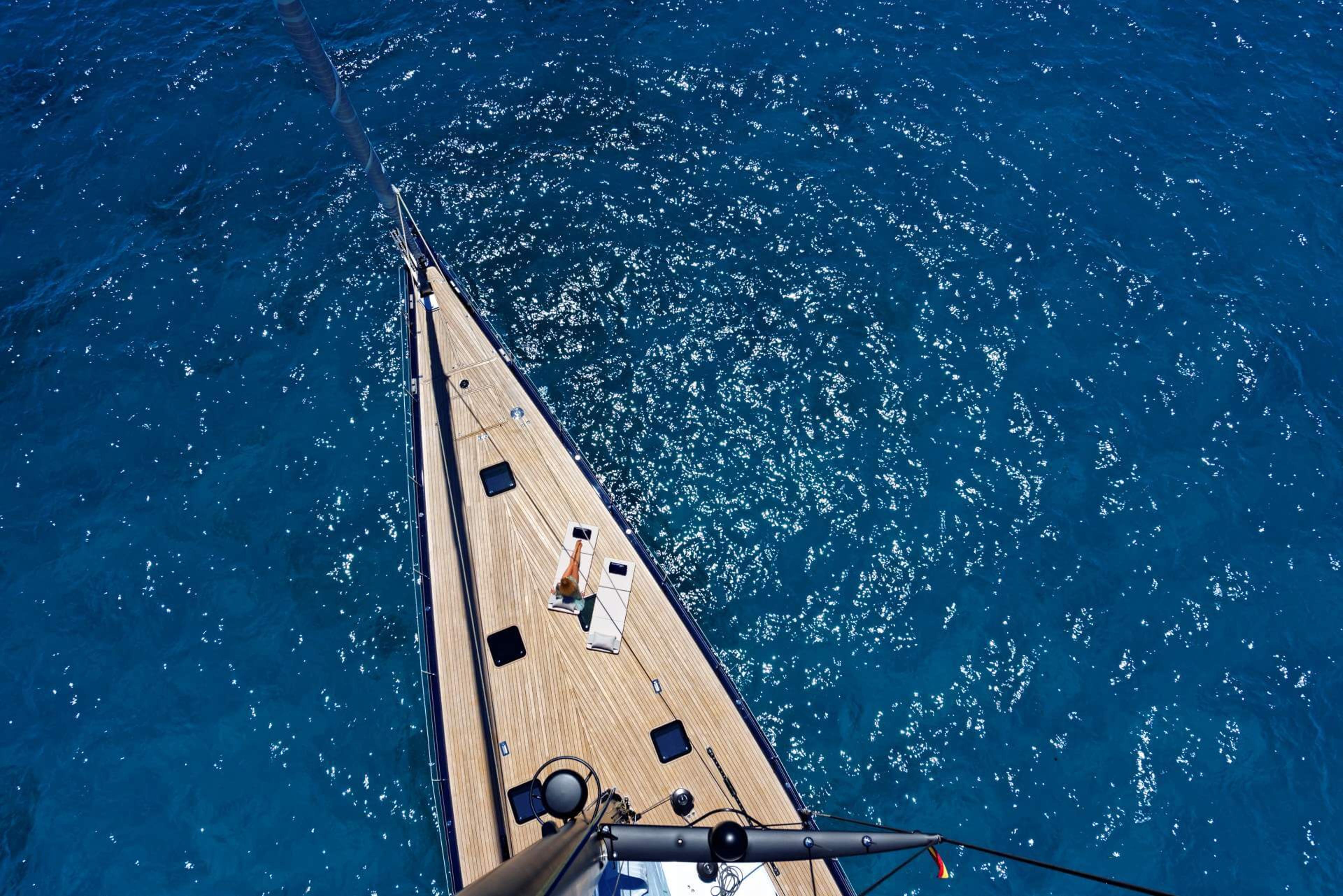 Nautor Swan 115 Shamanna sailing yacht view from sail looking down on yacht on deep blue water